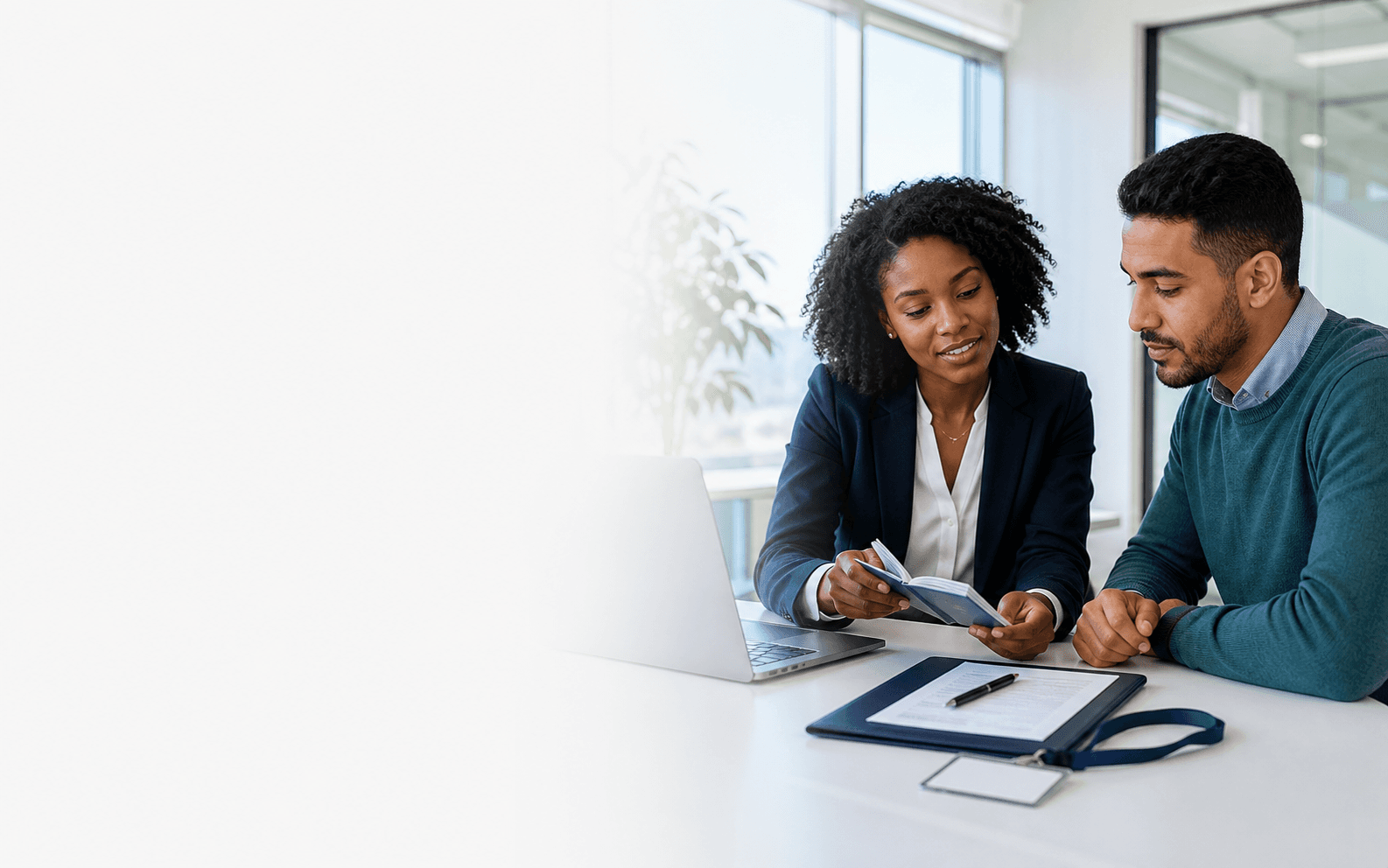 HR professional reviewing identity and onboarding documents with a new employee